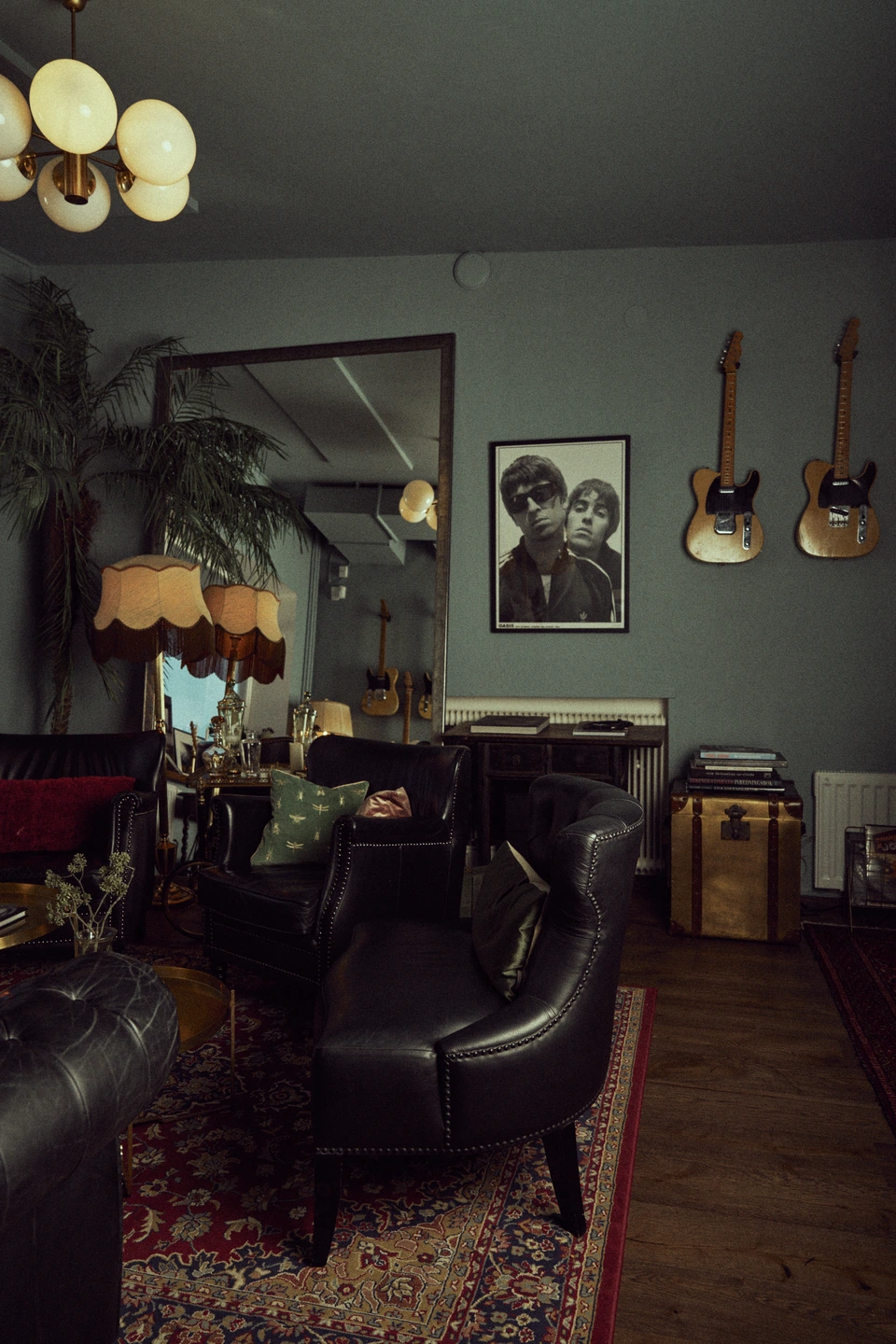 A welcoming studio lounge with leather chairs, guitars and photographs