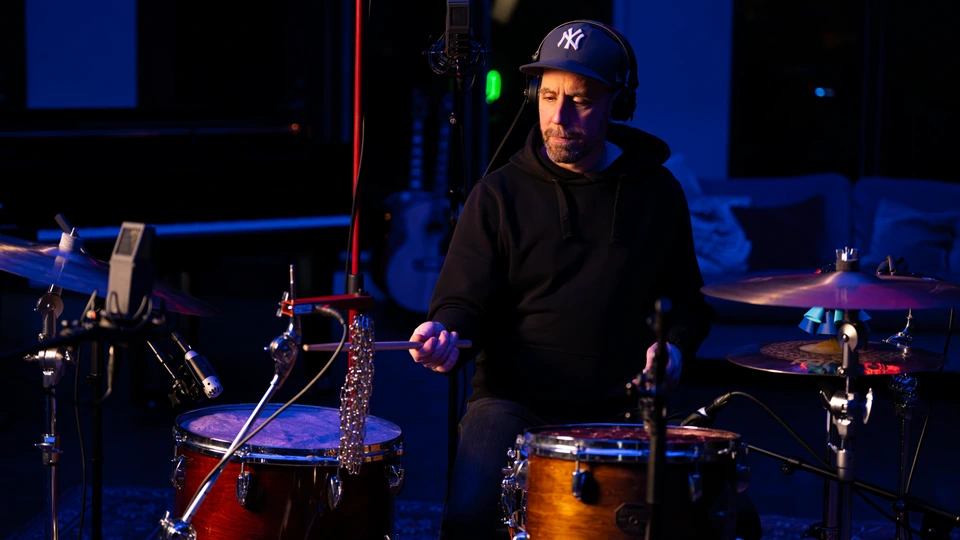 A drummer playing a microphone-equipped drum kit in Studio 1
