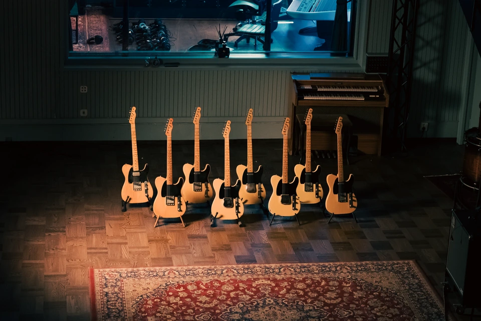 A collection of electric guitars in the recording room