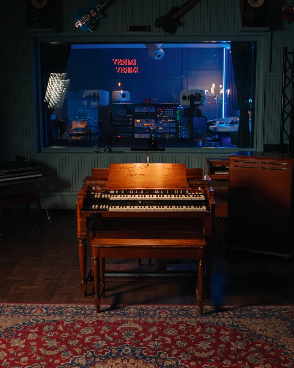 An organ and speaker cabinet beside the control room window